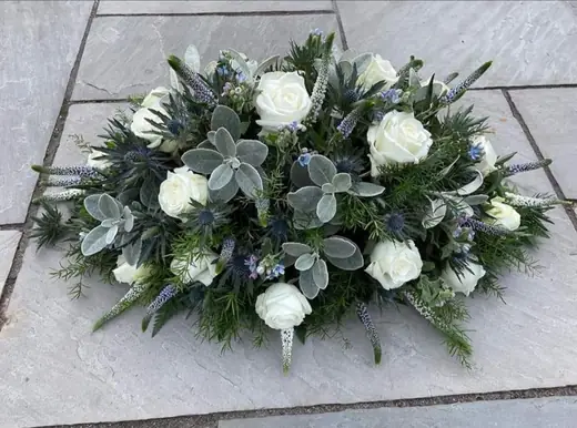 White rose coffin spray by Polly's Flowers